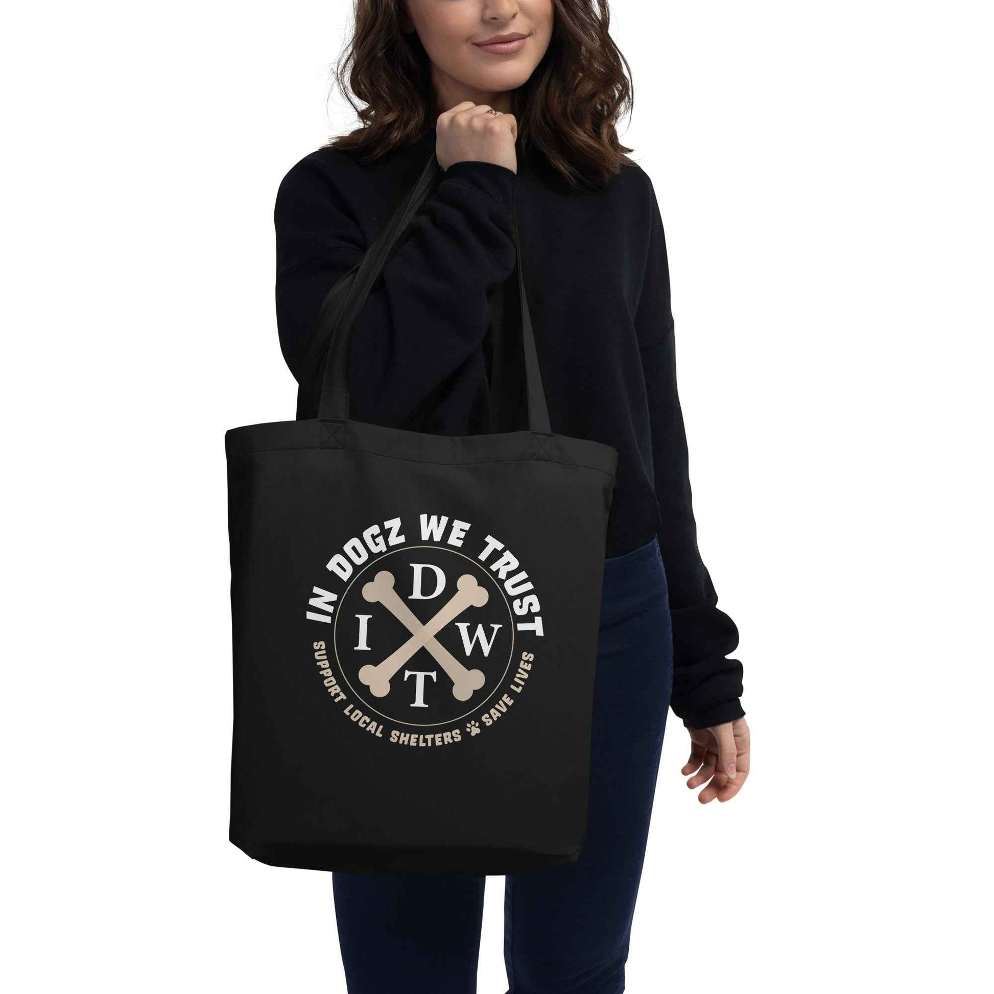 Doggy Bag: Eco Tote - In Dogz We Trust Logo on Black Canvas Tote - Female Model - Front View